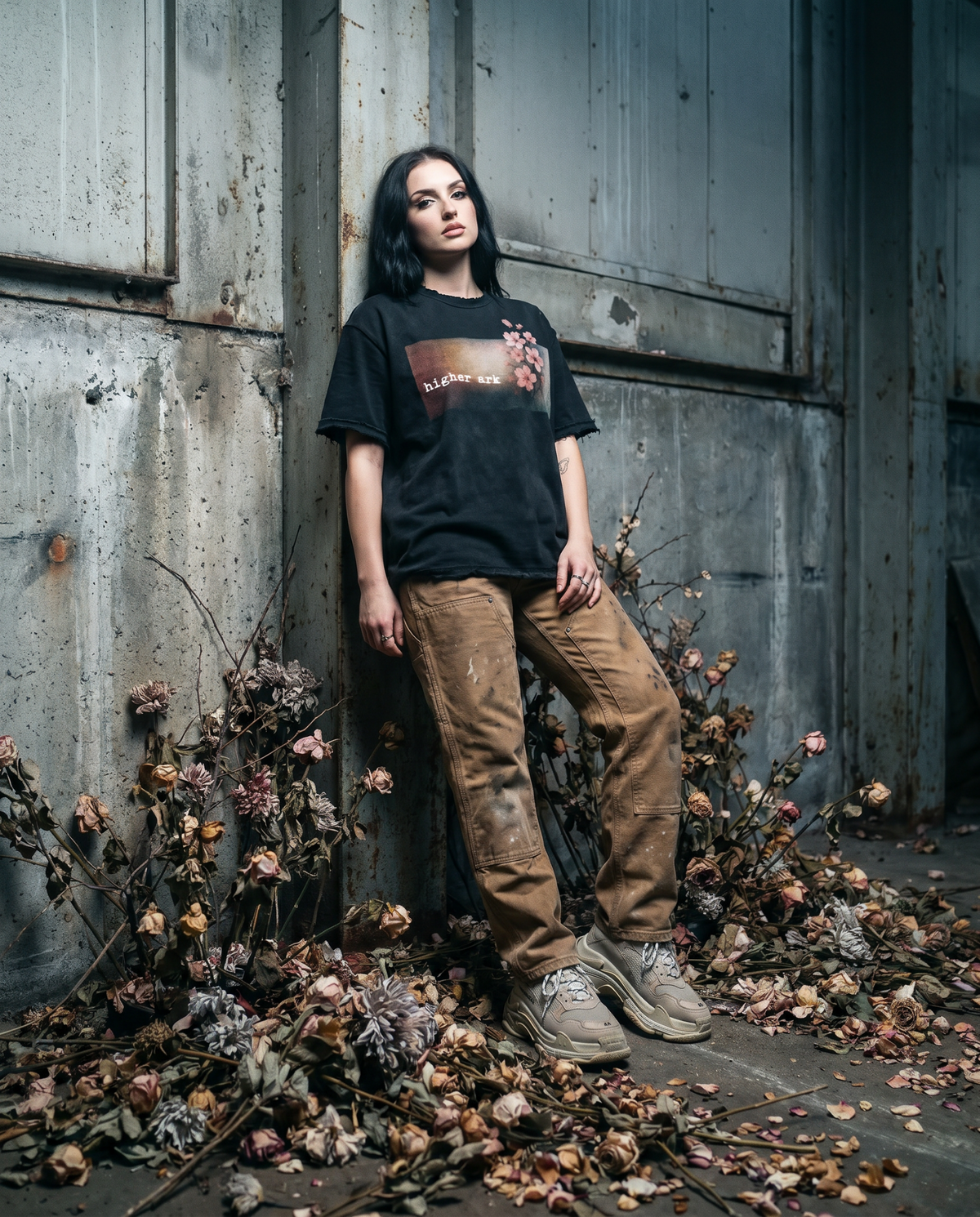 Model wearing the Higher Ark Fragile vintage washed graphic tee in an industrial setting