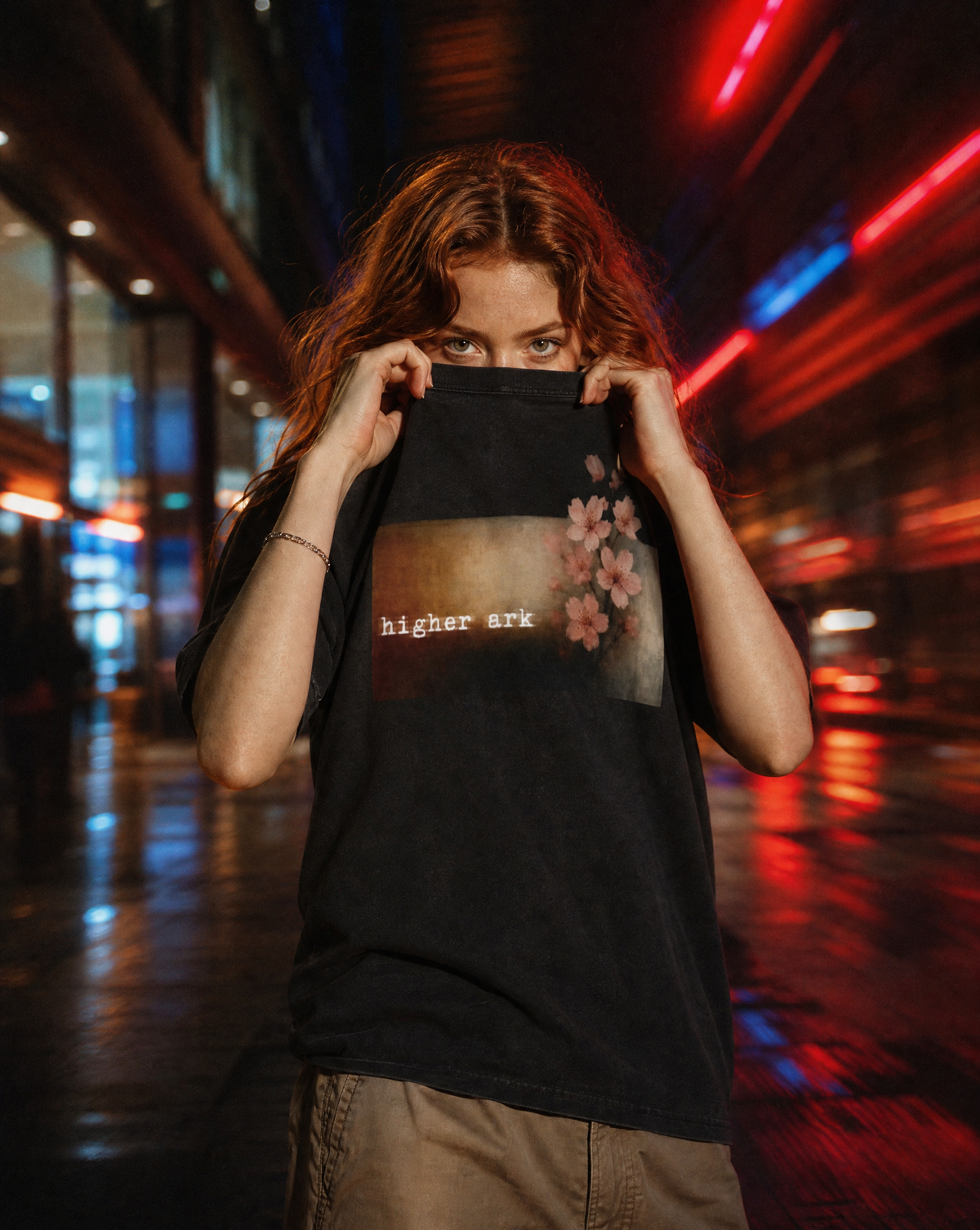 Close-up lifestyle photo of a model wearing the Higher Ark Fragile vintage washed graphic tee at night
