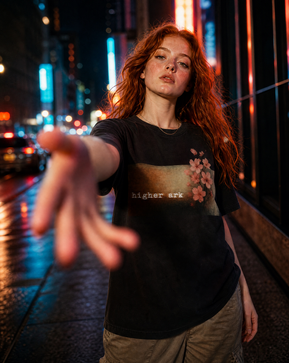 Model wearing the Higher Ark Fragile vintage washed graphic tee on a city street at night
